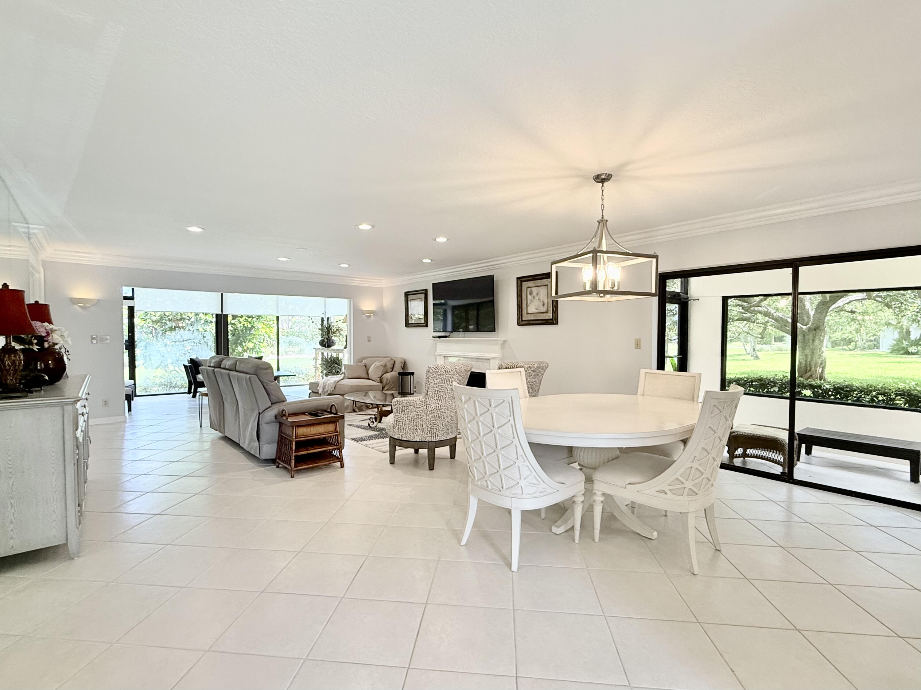 401 Clubhouse Circle, Unit 401A Jupiter, FL 33477 - Photo 3 of 34 a living room with furniture and a flat screen tv