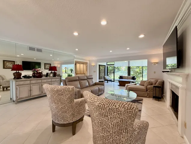 a living room with fireplace furniture and a flat screen tv