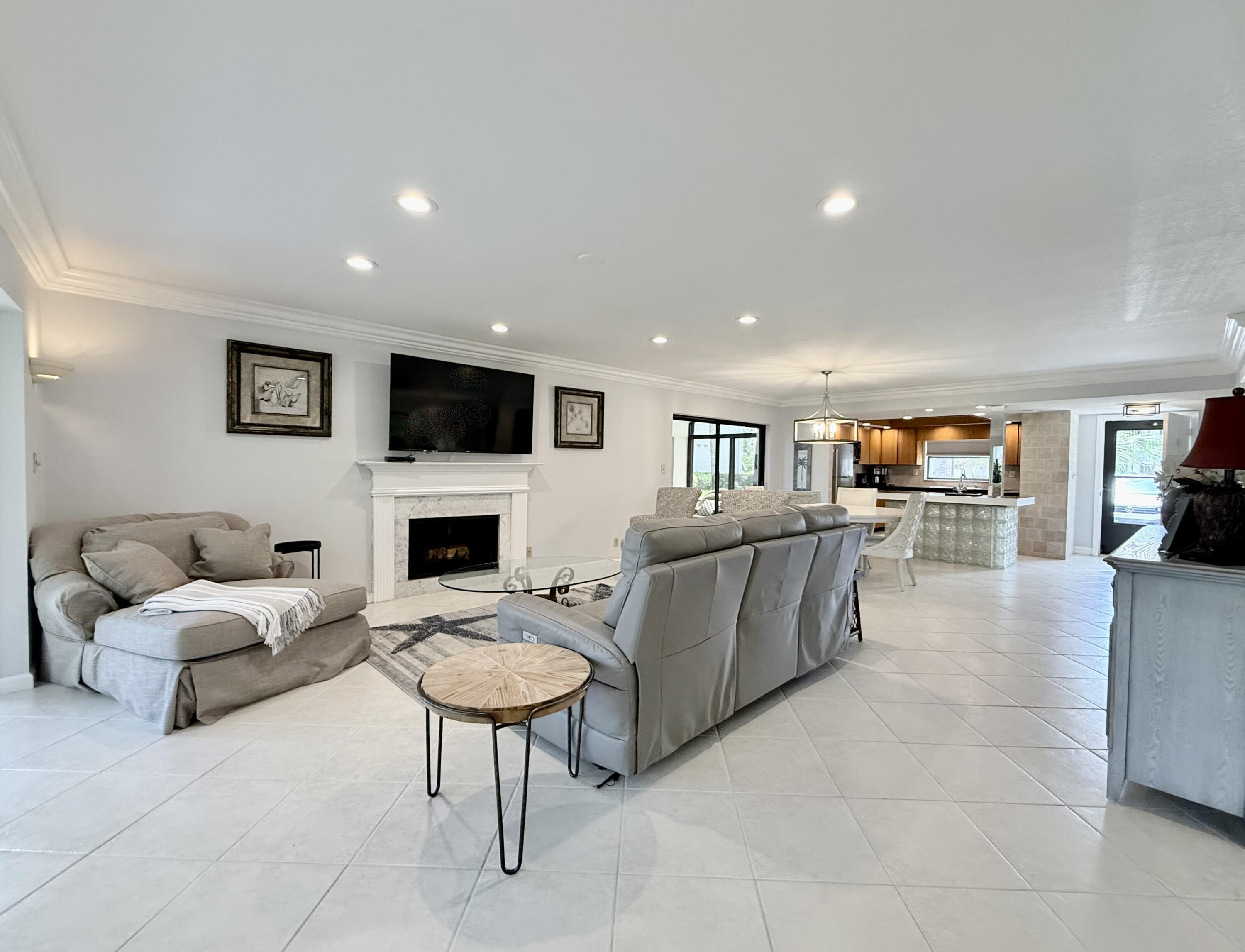 401 Clubhouse Circle, Unit 401A Jupiter, FL 33477 - Photo 10 of 34 a living room with furniture and a fireplace