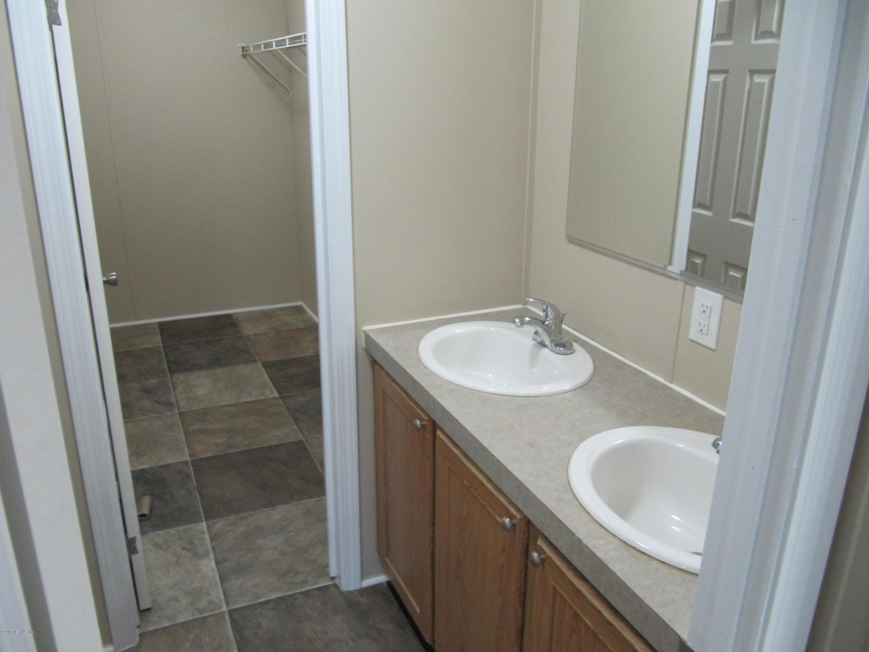 110 Putnam Loop Road Melrose, FL 32666 - Photo 5 of 7 a bathroom with a sink and a mirror