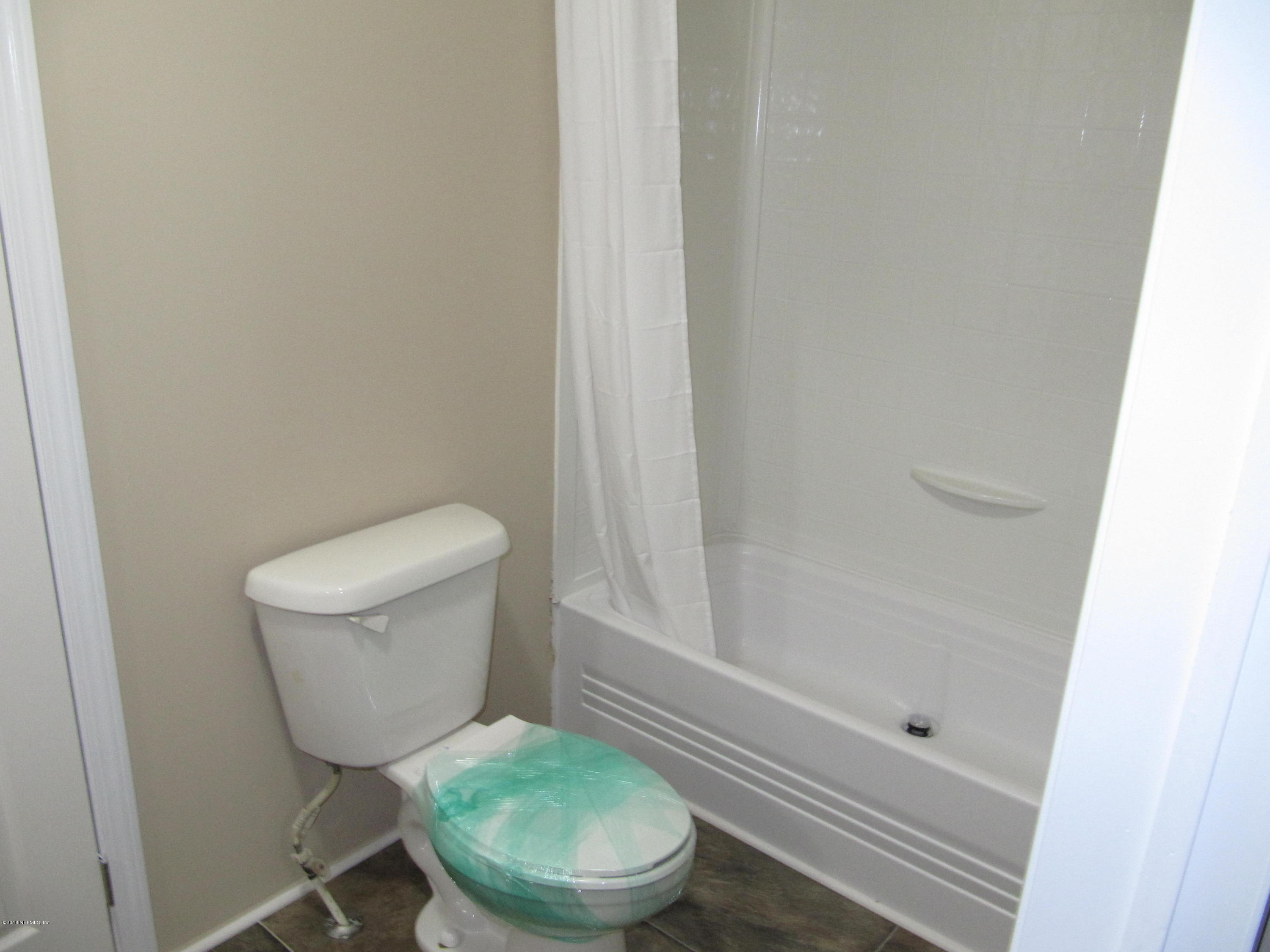 110 Putnam Loop Road Melrose, FL 32666 - Photo 6 of 7 a white toilet sitting next to a bath tub