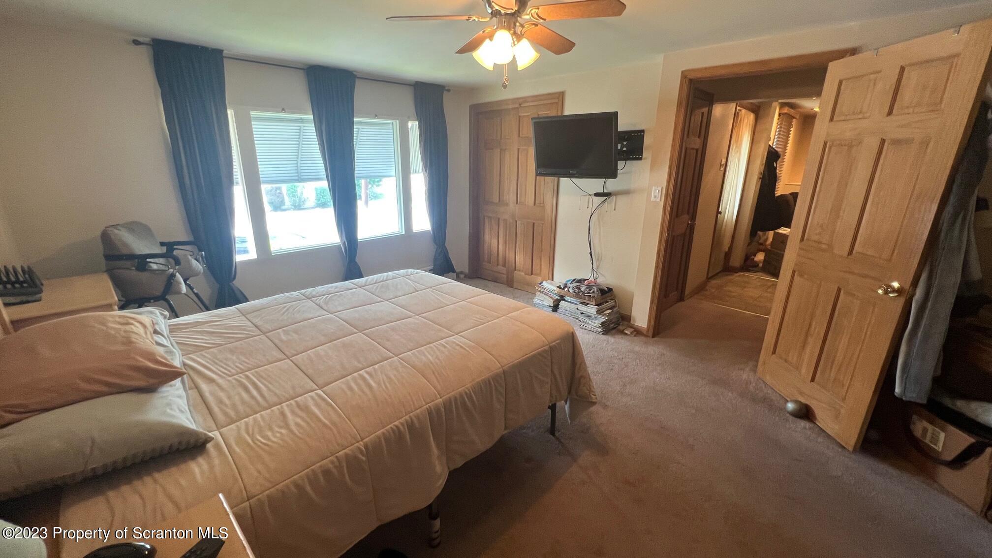 526 George Street Old Forge, PA 18518 - Photo 12 of 43 a bedroom with a bed a flat screen tv and a large window