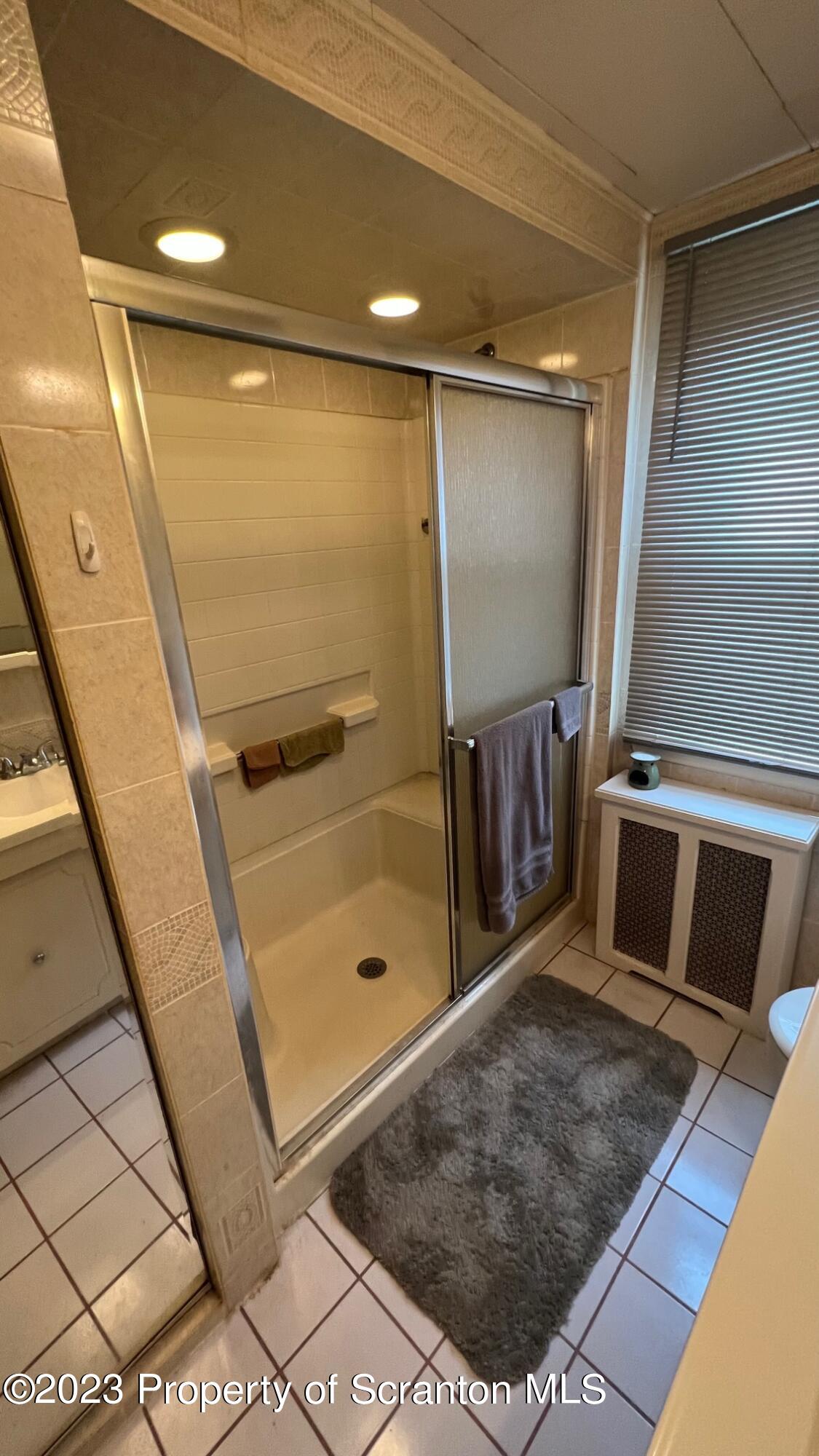 526 George Street Old Forge, PA 18518 - Photo 18 of 43 a bathroom with a glass shower door and a sink