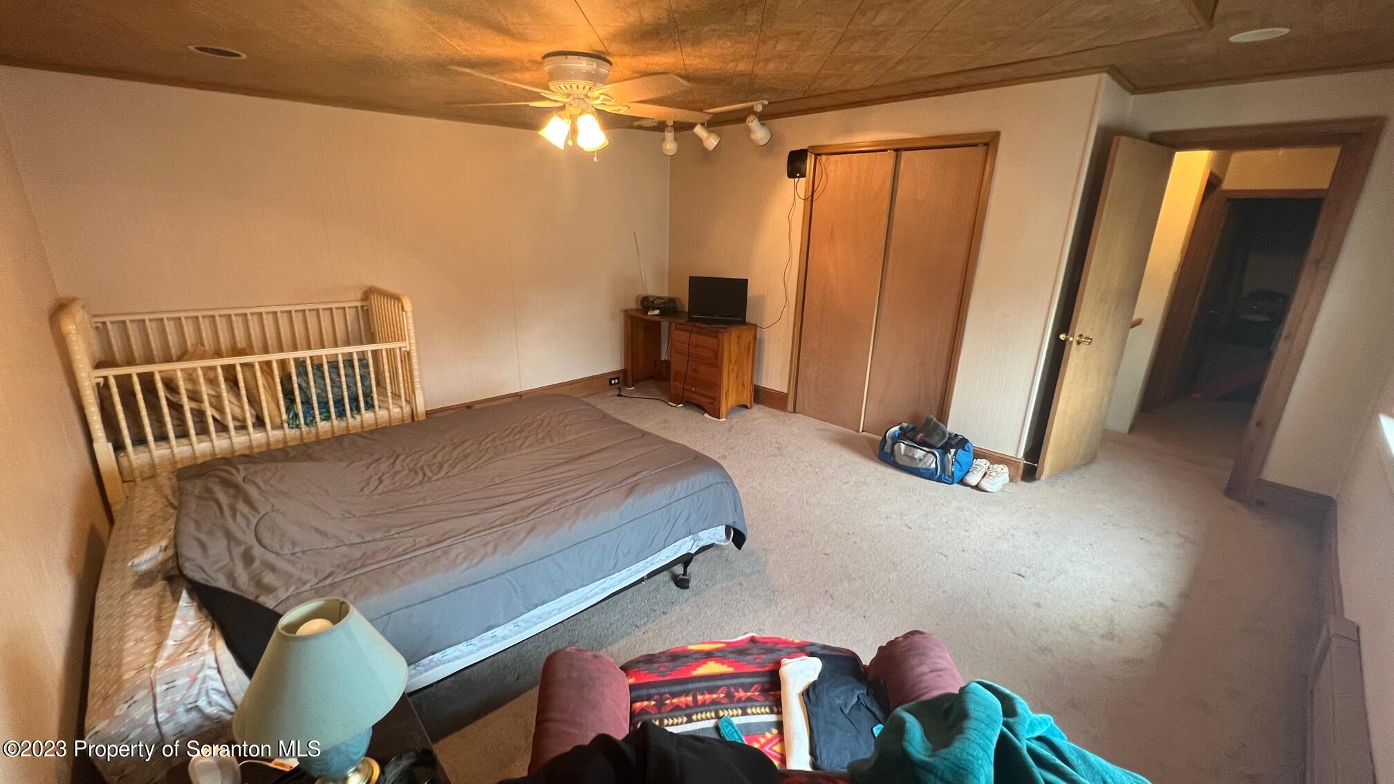 526 George Street Old Forge, PA 18518 - Photo 21 of 43 a bedroom with a bed and a window