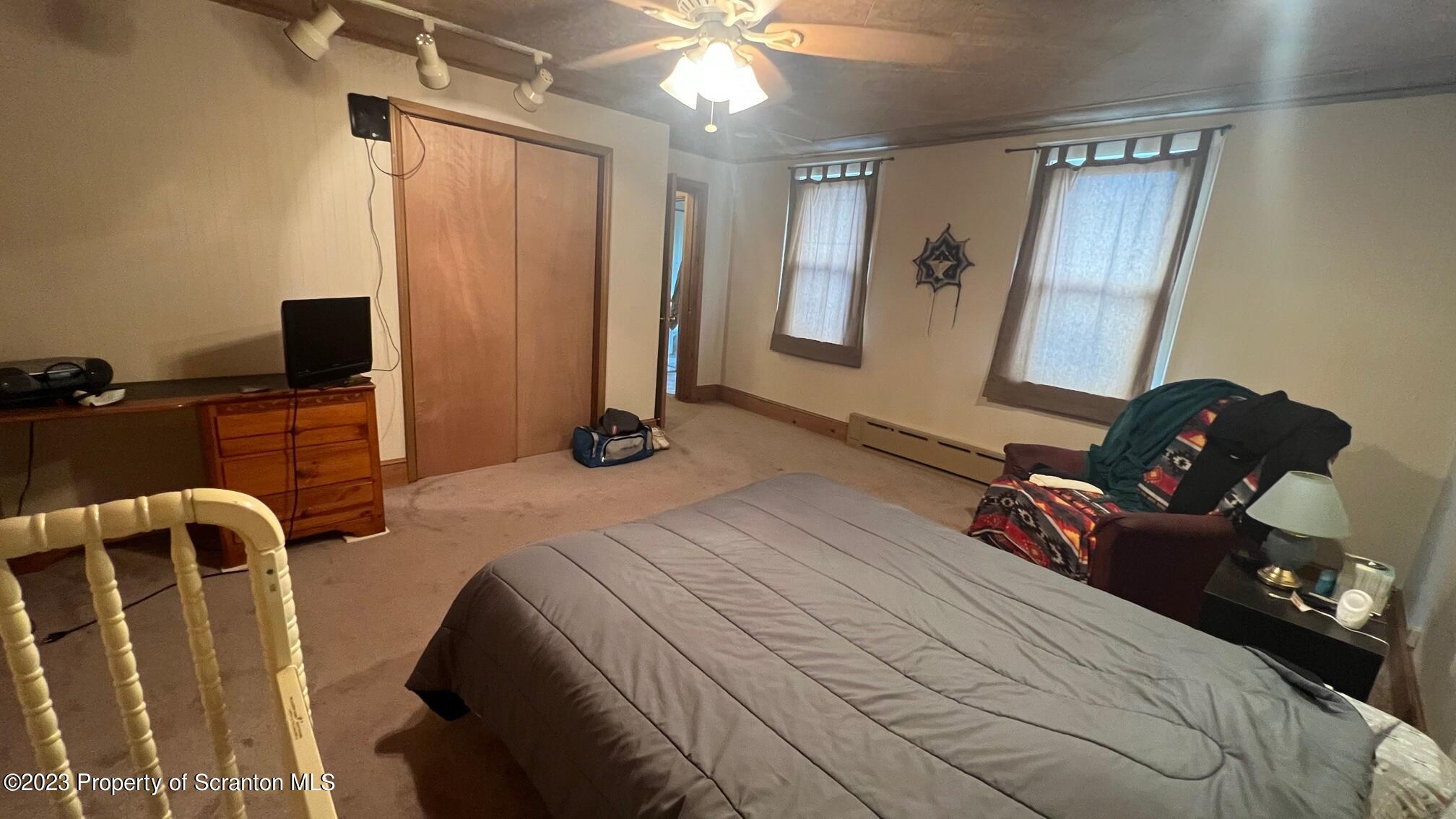 526 George Street Old Forge, PA 18518 - Photo 22 of 43 a bedroom with a bed and a chandelier