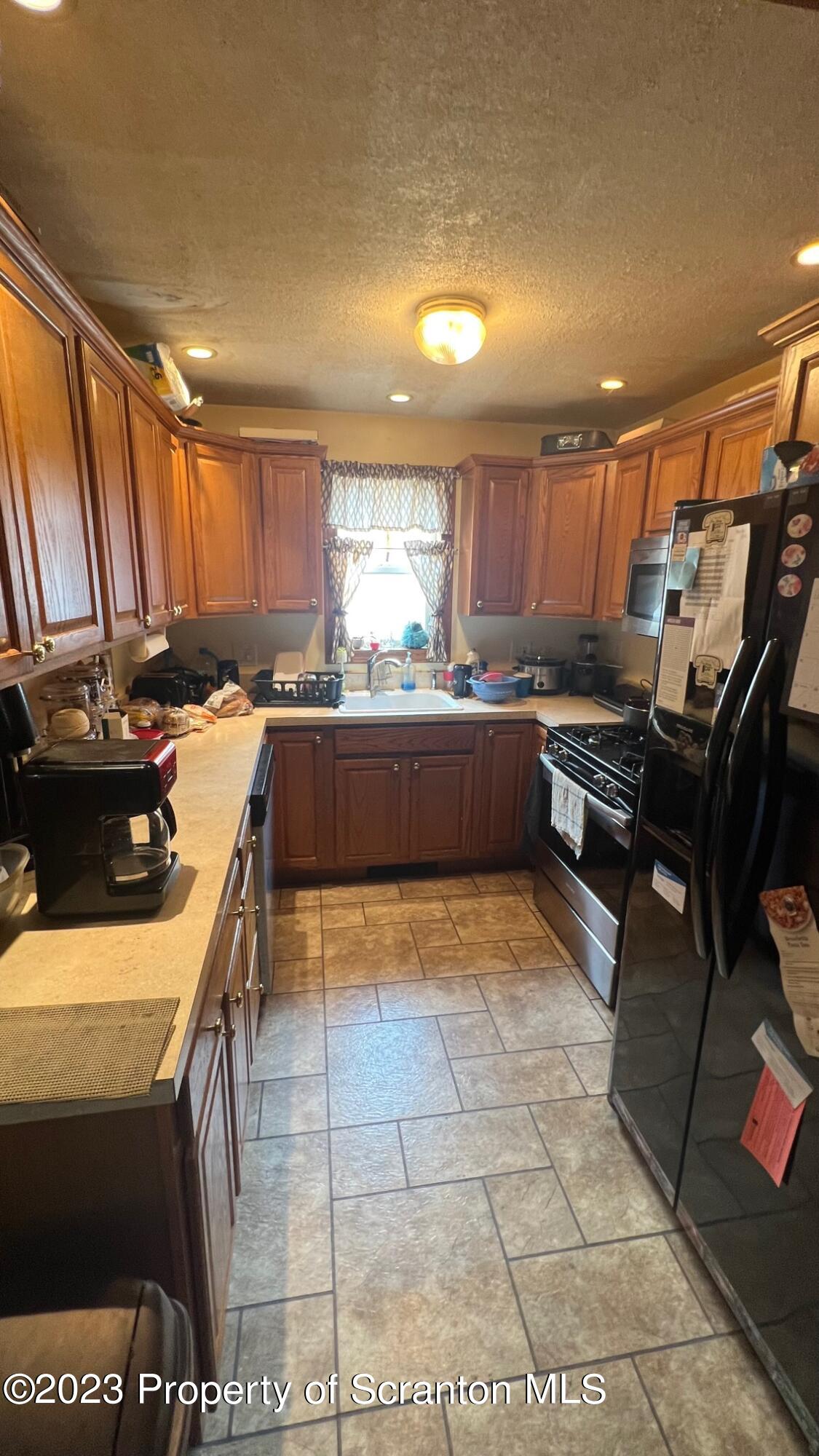 526 George Street Old Forge, PA 18518 - Photo 9 of 43 a kitchen with kitchen island granite countertop a sink and counter top space