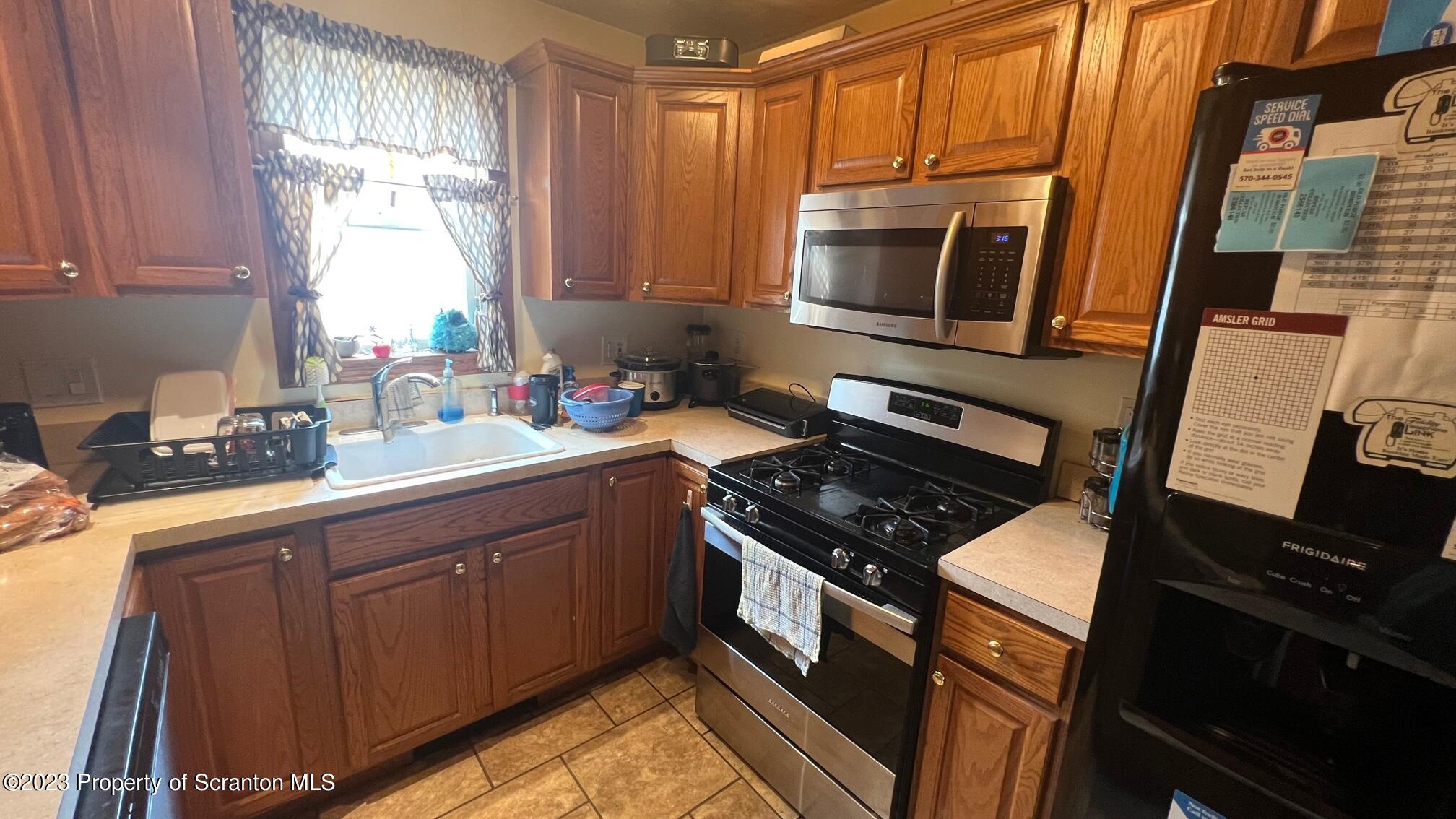526 George Street Old Forge, PA 18518 - Photo 10 of 43 a kitchen with a stove a sink and a microwave