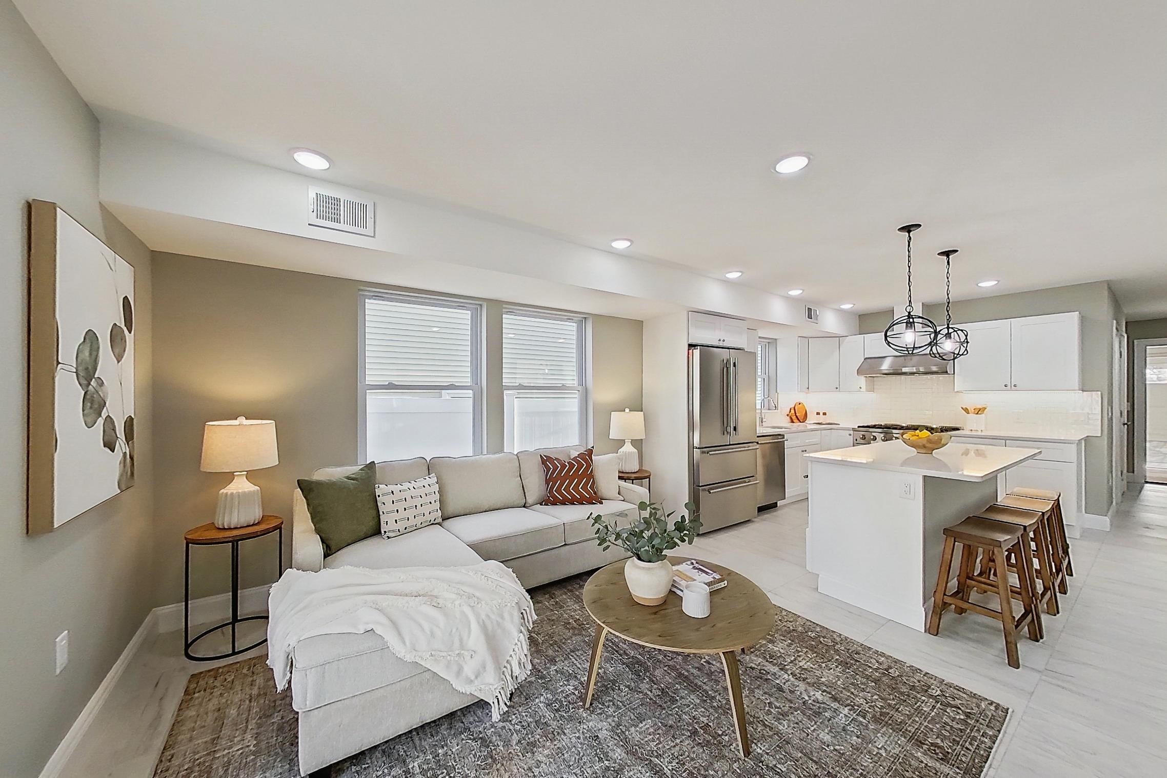 261 Winans Avenue Hillside, NJ 07205 - Photo 14 of 48 a living room with kitchen island furniture and a wooden floor