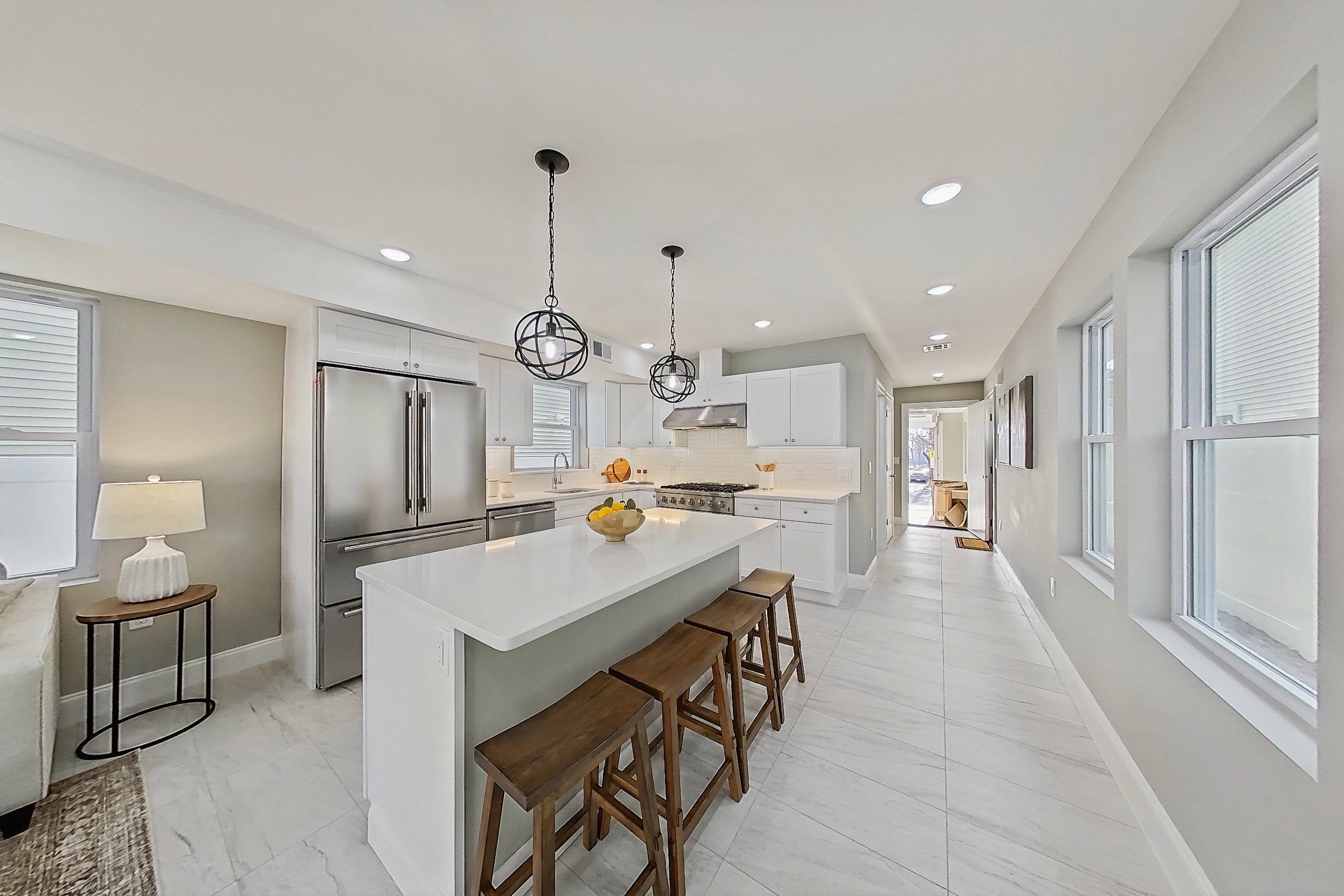 261 Winans Avenue Hillside, NJ 07205 - Photo 18 of 48 a very nice looking open dining room with kitchen island stainless steel appliances a table and chairs