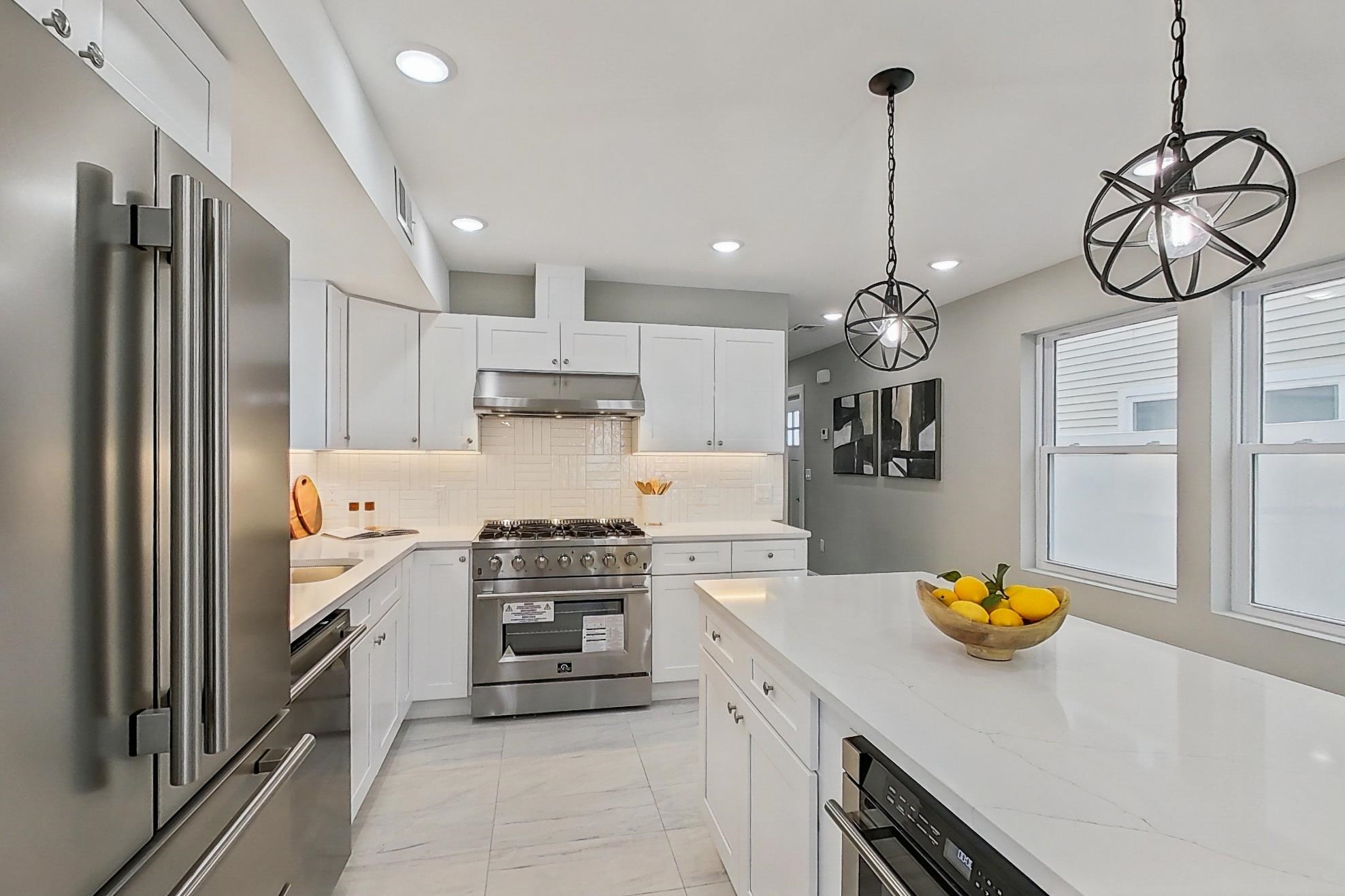 261 Winans Avenue Hillside, NJ 07205 - Photo 19 of 48 a kitchen with stainless steel appliances granite countertop a sink a stove and a refrigerator