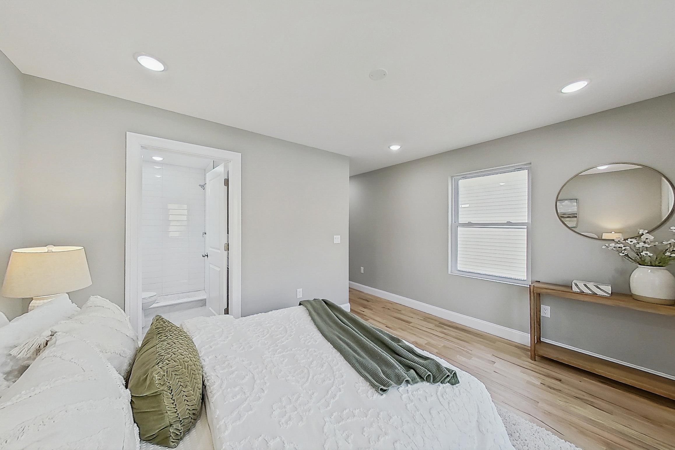 261 Winans Avenue Hillside, NJ 07205 - Photo 34 of 48 a bedroom with a bed and a mirror