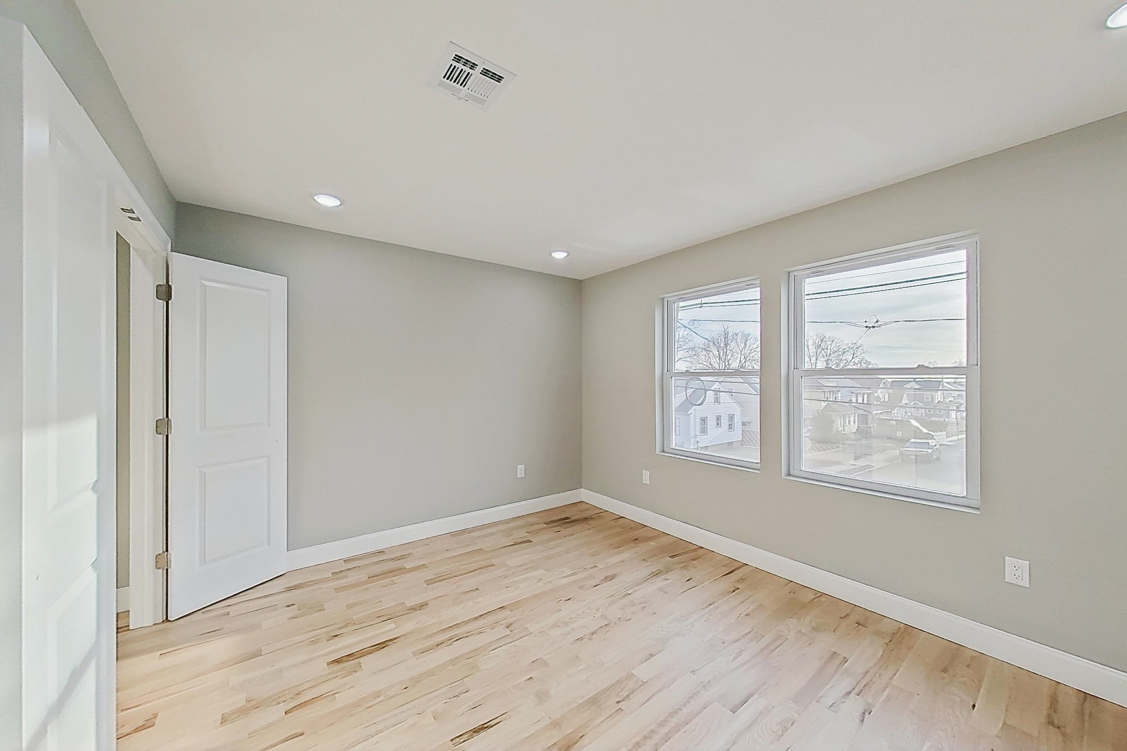 261 Winans Avenue Hillside, NJ 07205 - Photo 37 of 48 a view of empty room with wooden floor and fan