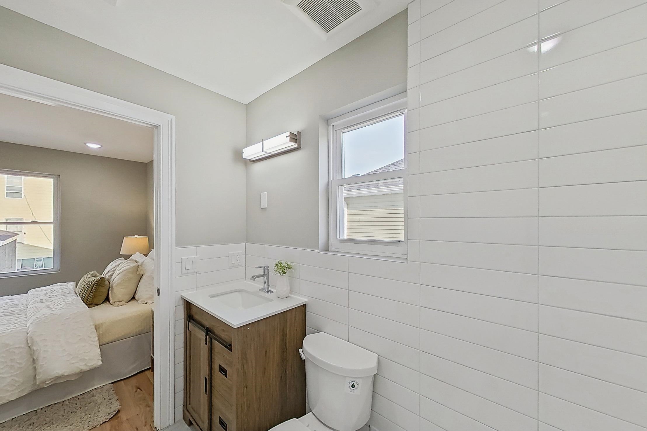 261 Winans Avenue Hillside, NJ 07205 - Photo 45 of 48 a bathroom with a sink a toilet and mirror