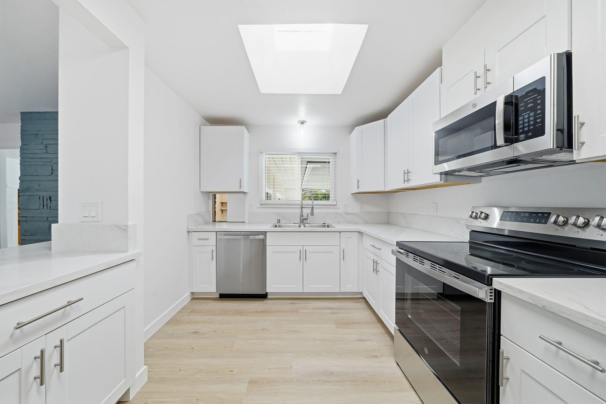 3911 Roesner Avenue Redding, CA 96002 - Photo 11 of 42 a kitchen with a sink stove and microwave