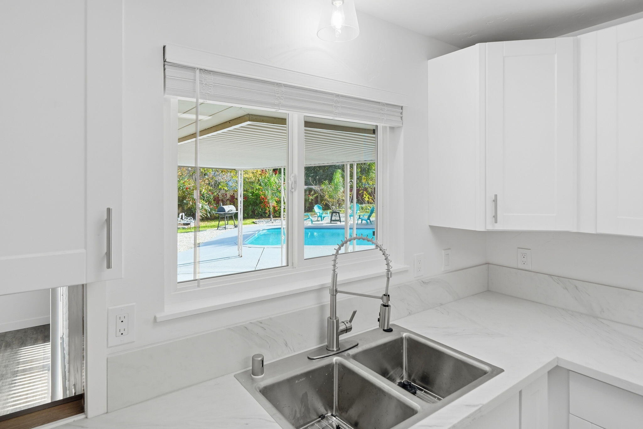 3911 Roesner Avenue Redding, CA 96002 - Photo 12 of 42 a kitchen with a sink and large window