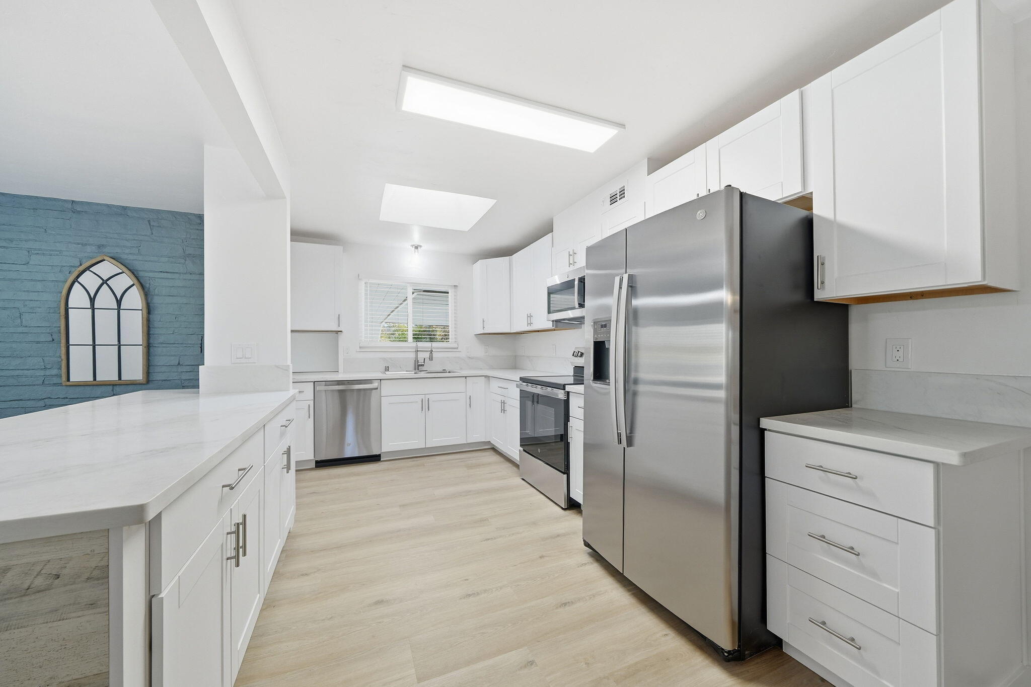 3911 Roesner Avenue Redding, CA 96002 - Photo 10 of 42 a kitchen with stainless steel appliances a refrigerator sink and cabinets