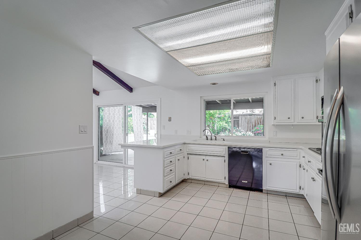 Undisclosed Address Bakersfield, CA 93309 - Photo 12 of 34 a large kitchen with white cabinets and white appliances