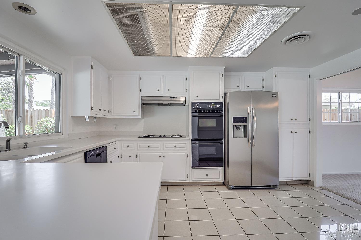 Undisclosed Address Bakersfield, CA 93309 - Photo 15 of 34 a kitchen with stainless steel appliances a refrigerator sink and cabinets