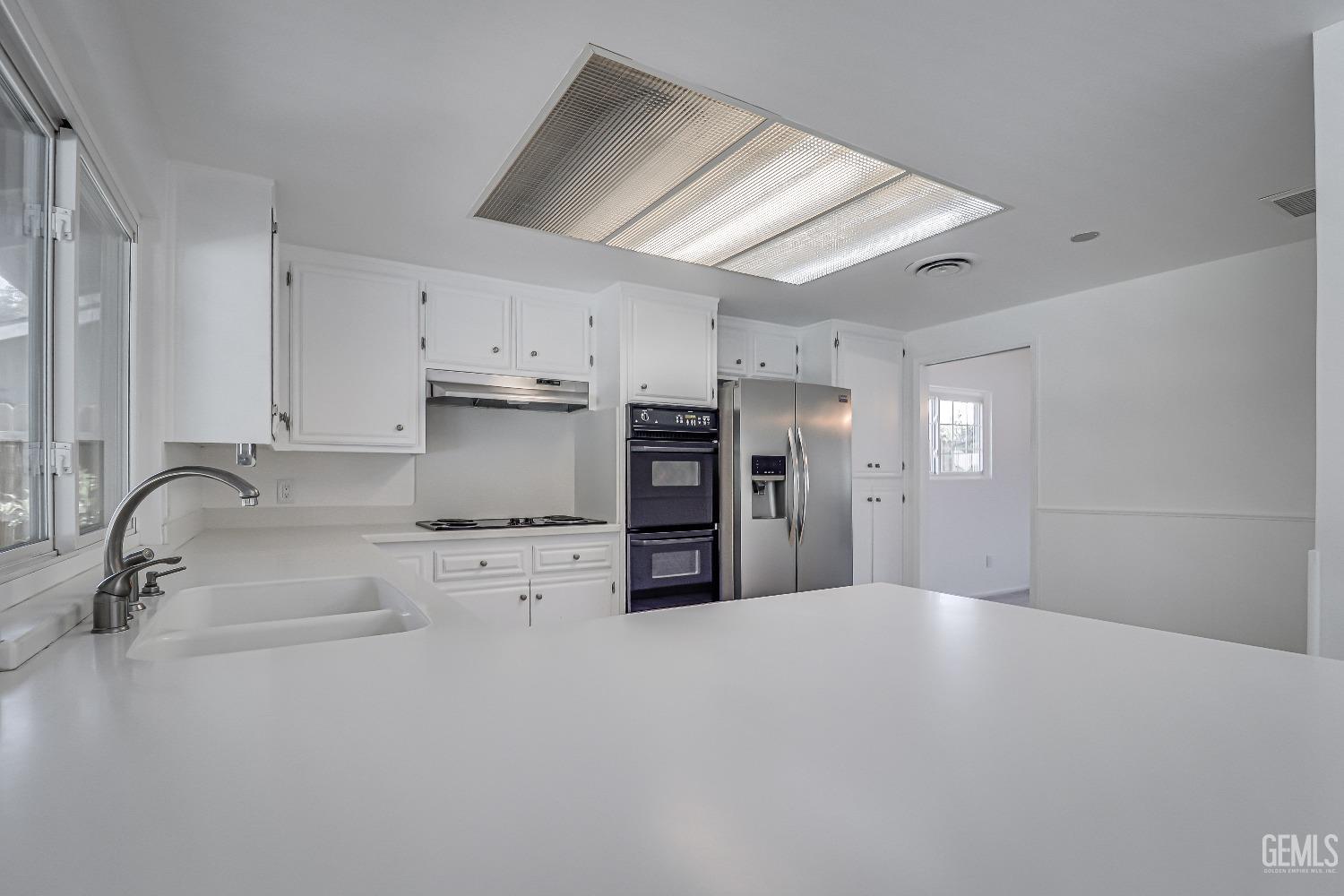 Undisclosed Address Bakersfield, CA 93309 - Photo 16 of 34 a kitchen with stainless steel appliances a sink and cabinets