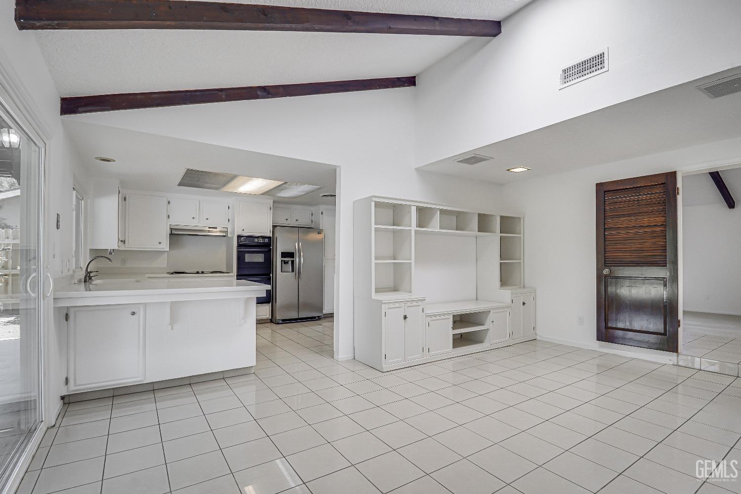 Undisclosed Address Bakersfield, CA 93309 - Photo 18 of 34 a kitchen with white cabinets and refrigerator