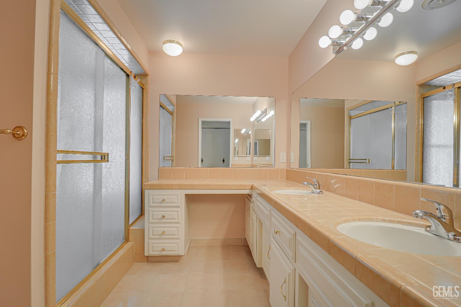 Undisclosed Address Bakersfield, CA 93309 - Photo 25 of 34 a spacious bathroom with a granite countertop sink a mirror and a shower