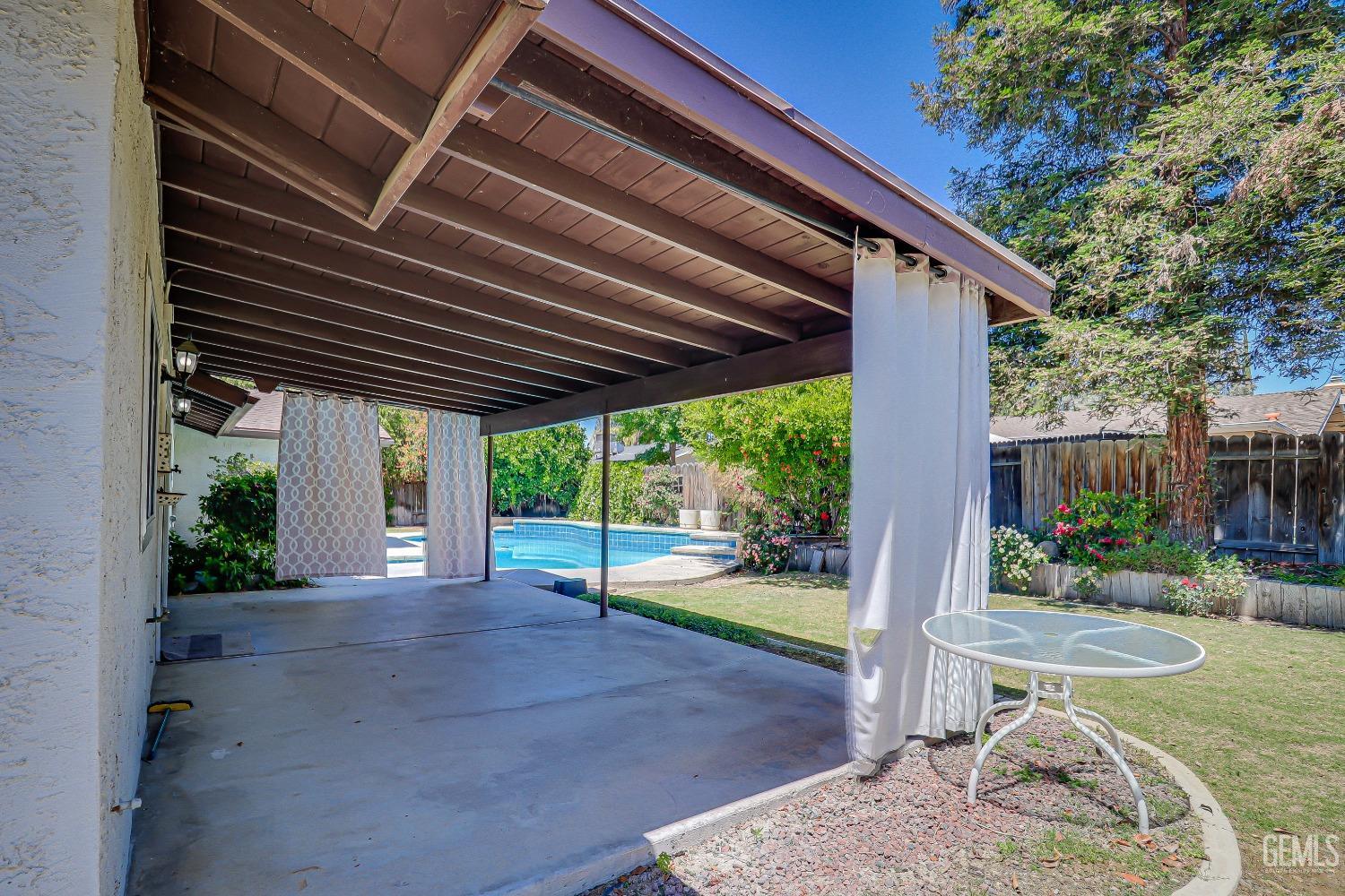 Undisclosed Address Bakersfield, CA 93309 - Photo 29 of 34 a patio with a table and chairs and potted plants