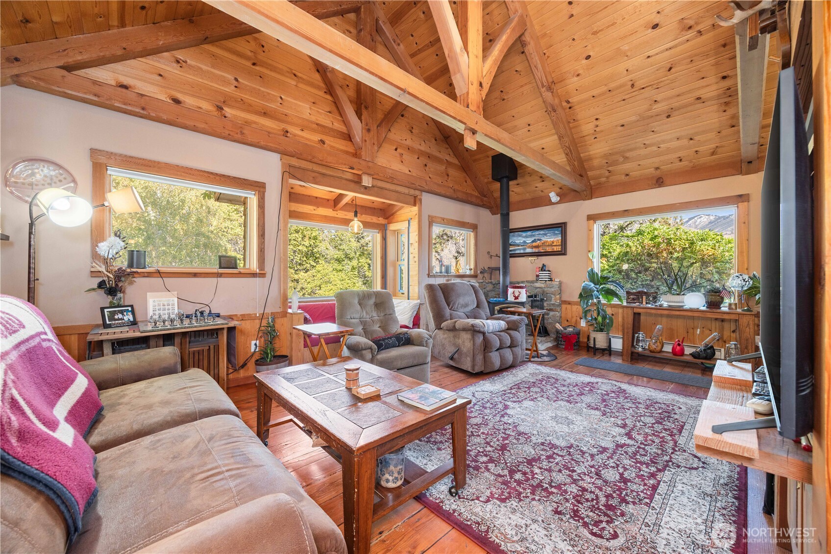 16495 South Lakeshore Road Chelan, WA 98816 - Photo 8 of 40 a living room with furniture a large window and wooden floor