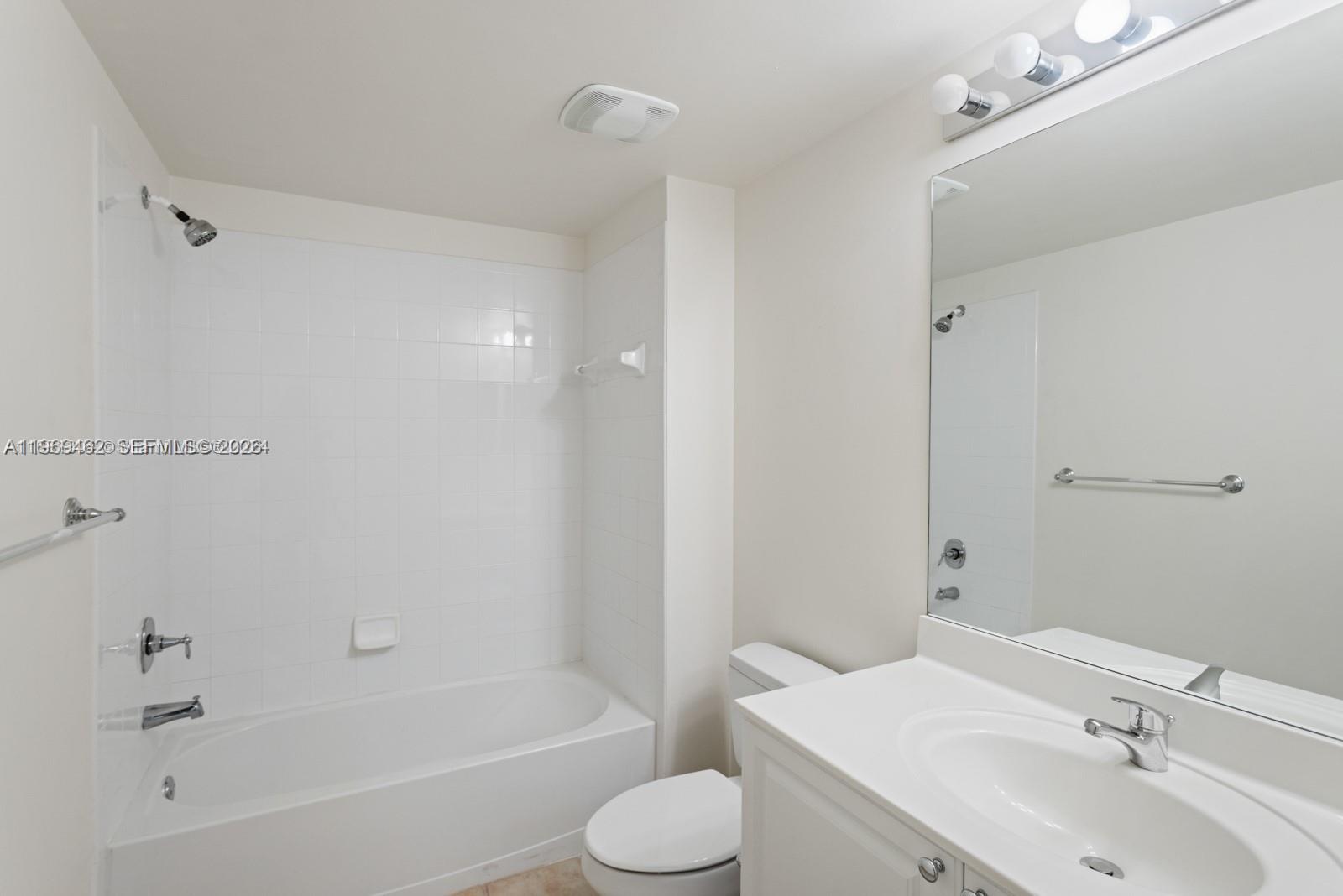 888 Douglas Road, Unit 1405 Coral Gables, FL 33134 - Photo 11 of 42 a bathroom with a sink toilet and bathtub