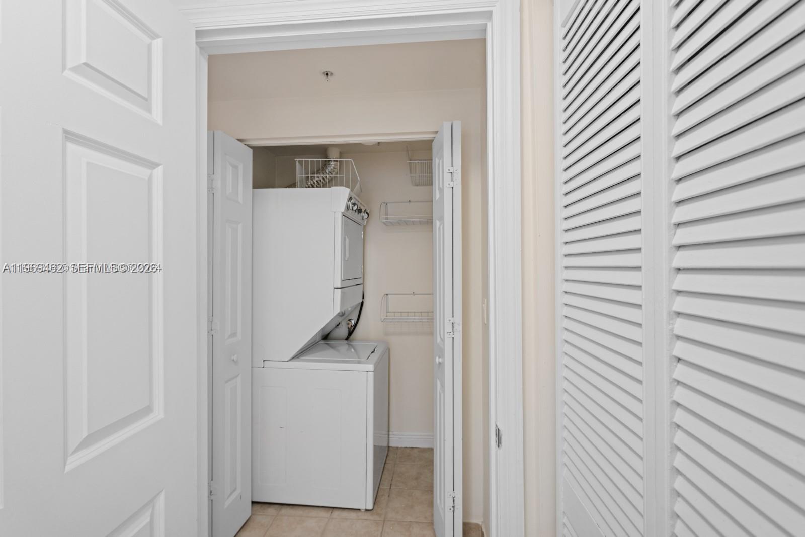 888 Douglas Road, Unit 1405 Coral Gables, FL 33134 - Photo 20 of 42 a utility room with closet dryer and washer