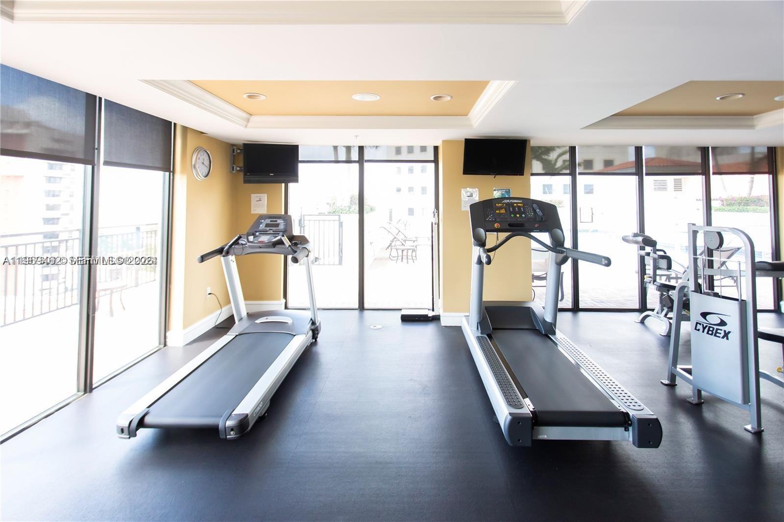 888 Douglas Road, Unit 1405 Coral Gables, FL 33134 - Photo 30 of 42 a room with gym equipment with a large window