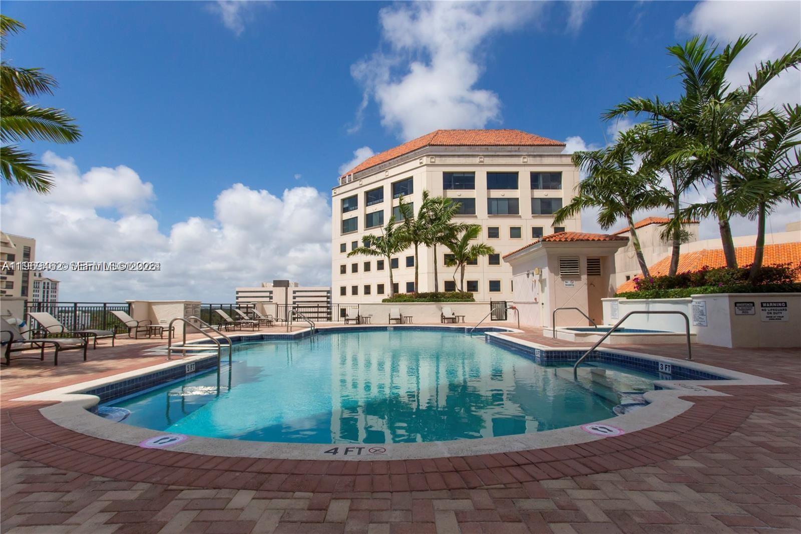 888 Douglas Road, Unit 1405 Coral Gables, FL 33134 - Photo 31 of 42 a view of a swimming pool with outdoor seating
