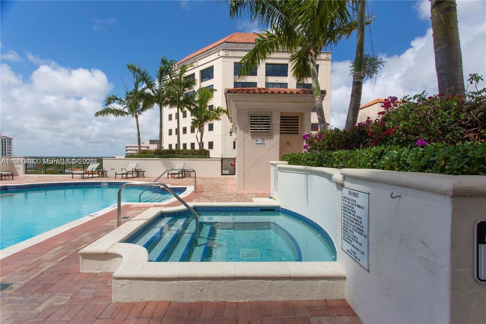 888 Douglas Road, Unit 1405 Coral Gables, FL 33134 - Photo 33 of 42 a swimming pool with outdoor seating and yard