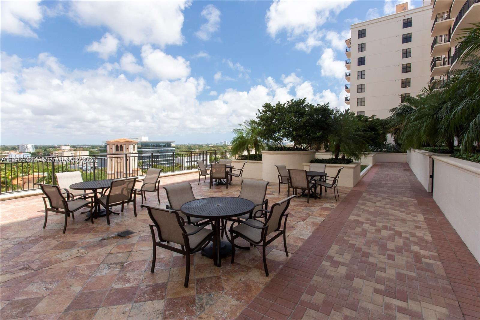 888 Douglas Road, Unit 1405 Coral Gables, FL 33134 - Photo 37 of 42 a view of a dinning tables and chairs in the patio
