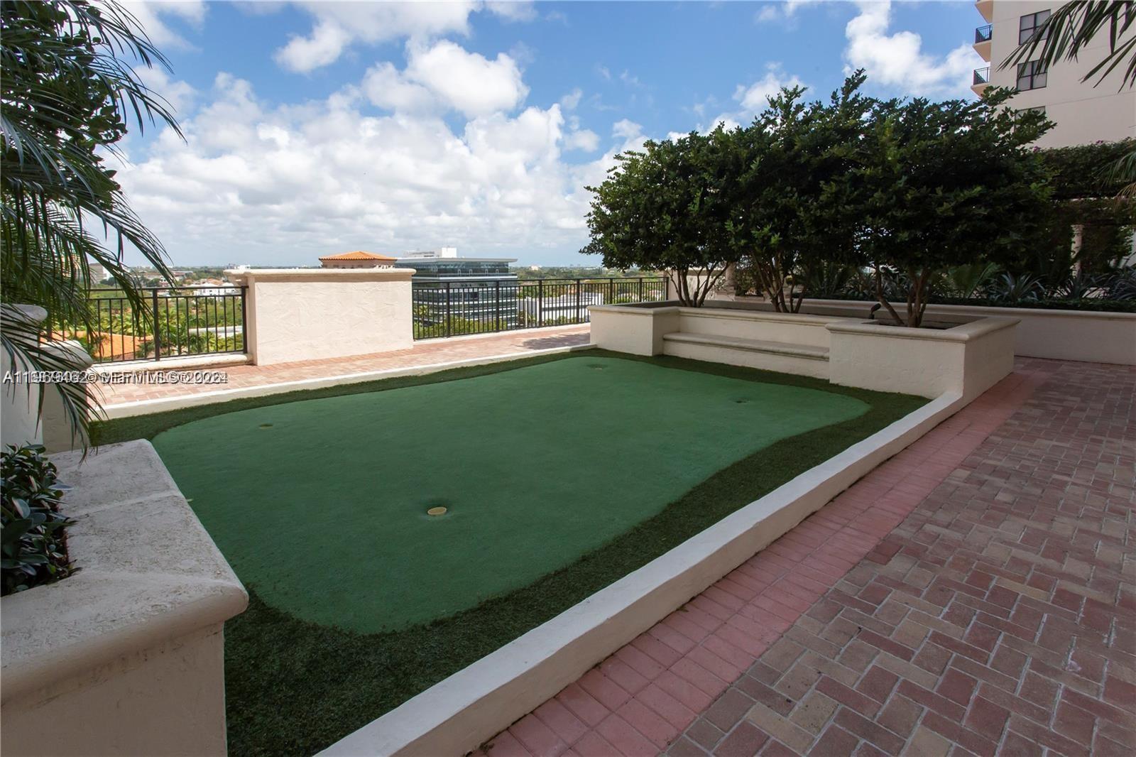 888 Douglas Road, Unit 1405 Coral Gables, FL 33134 - Photo 39 of 42 a view of a pool with a yard