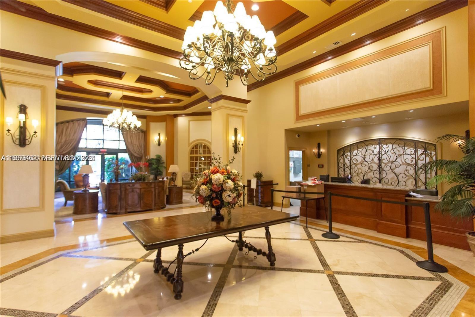 888 Douglas Road, Unit 1405 Coral Gables, FL 33134 - Photo 41 of 42 a living room with couches and a dining table with chandelier