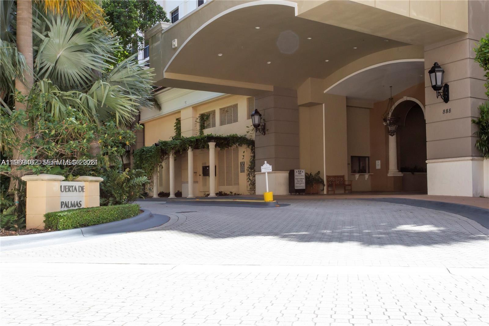 888 Douglas Road, Unit 1405 Coral Gables, FL 33134 - Photo 42 of 42 a front view of a house with a yard and garage