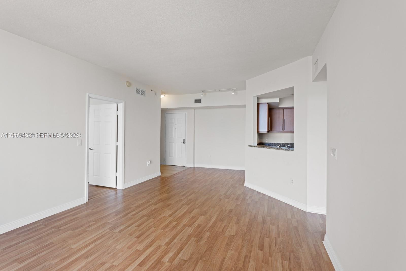 888 Douglas Road, Unit 1405 Coral Gables, FL 33134 - Photo 7 of 42 a view of empty room with wooden floor
