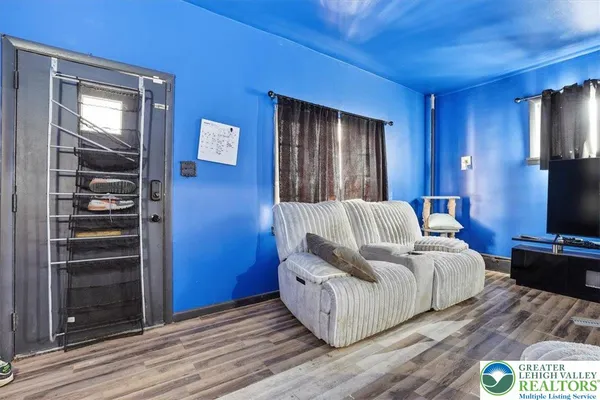a room with wooden floor and furniture