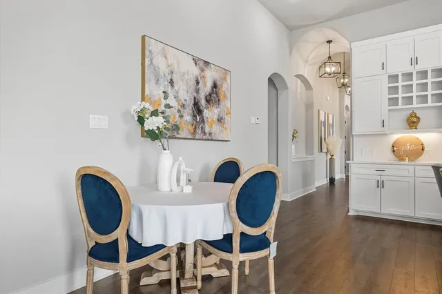 a kitchen with stainless steel appliances white cabinets and a window