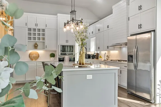 a bedroom with a large bed couch and a window