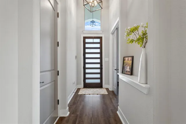 a view of hallway with stairs and wooden floor