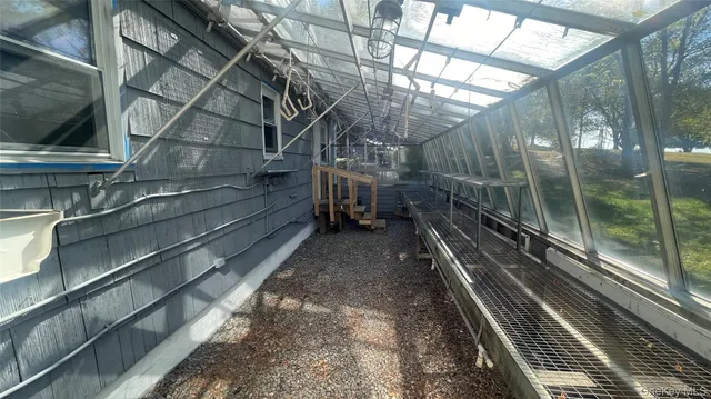 a view of a hallway with wooden floor and furniture