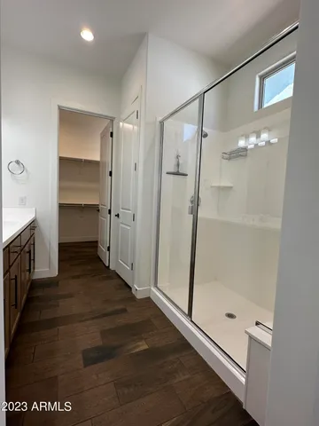 a bathroom with a glass shower door and a sink