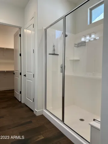 a bathroom with a glass shower door and a sink