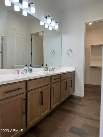 a bathroom with a double vanity sink and a mirror