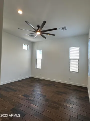 a view of an empty room window and wooden floor