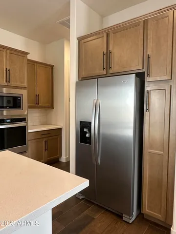 a kitchen with metallic refrigerator freezer and a dishwasher