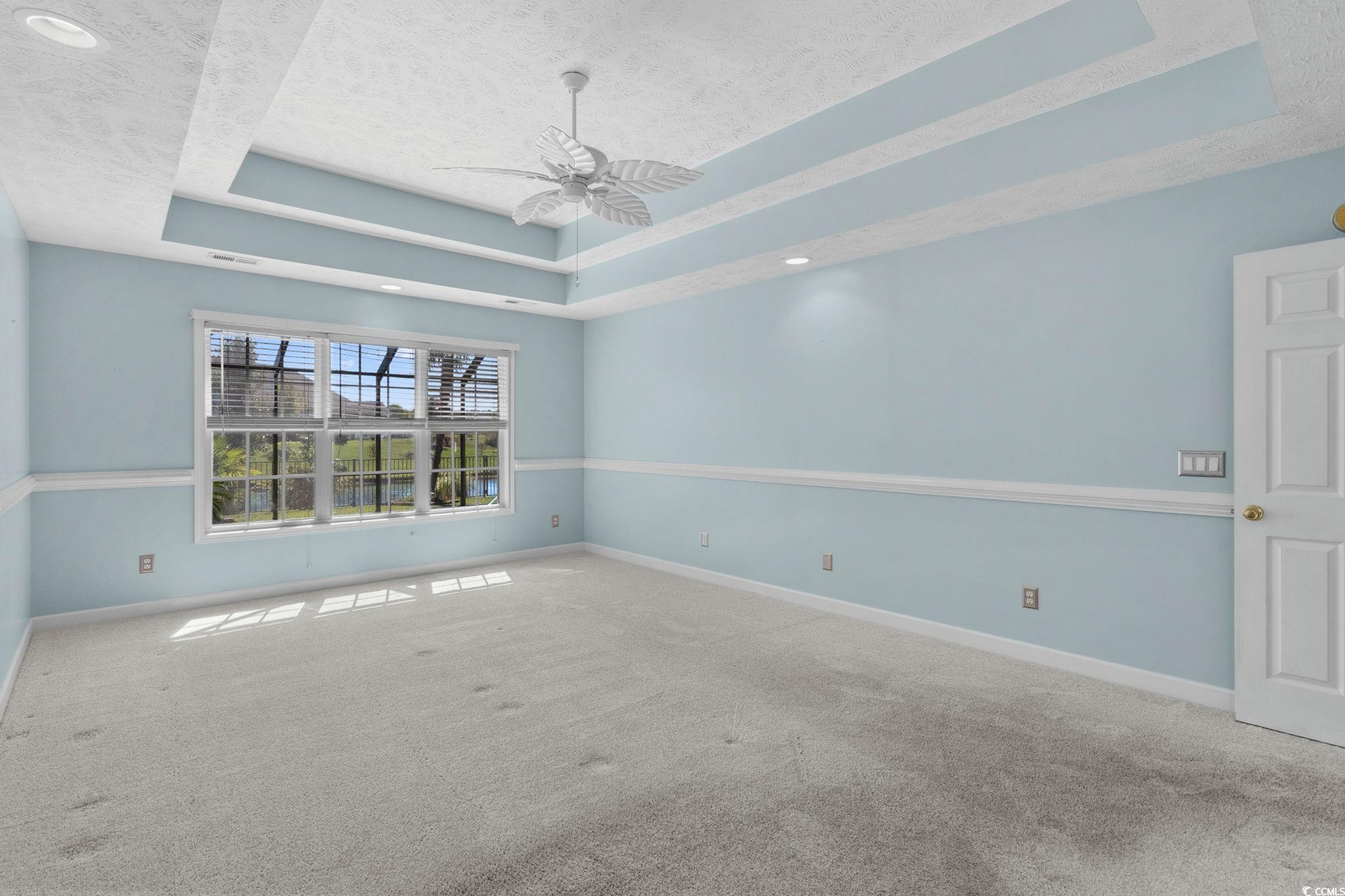 613 Broad River Road Myrtle Beach, SC 29588 - Photo 22 of 40 Carpeted empty room with a tray ceiling, ceiling fan, a textured ceiling, and recessed lighting