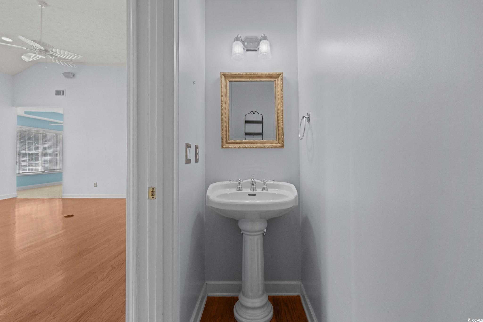 613 Broad River Road Myrtle Beach, SC 29588 - Photo 29 of 40 Half bathroom with wood finished floors, lofted ceiling, a ceiling fan, and a textured ceiling