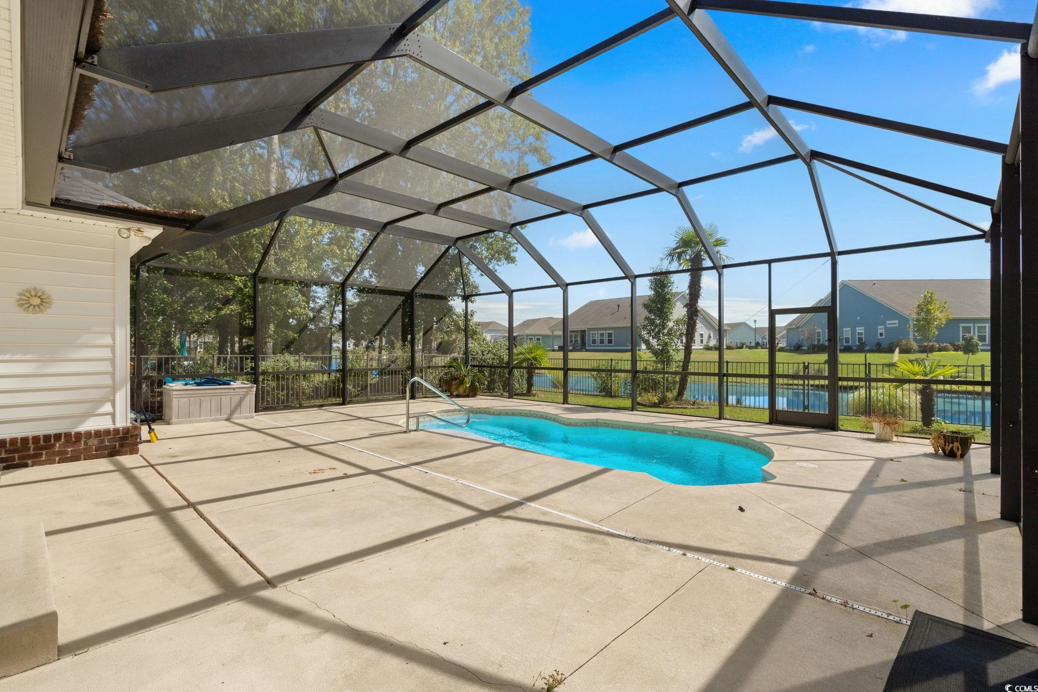 613 Broad River Road Myrtle Beach, SC 29588 - Photo 32 of 40 Swimming pool featuring a residential view, a patio, a lanai, and a water view